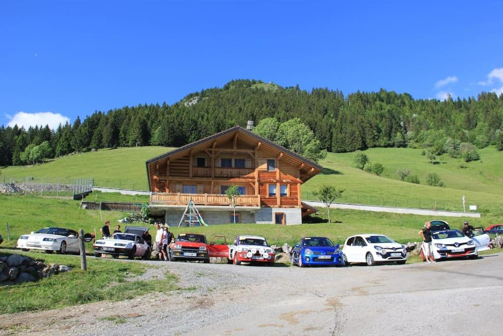 a group of cars parked in front of a log house at STUDIO in Montmin