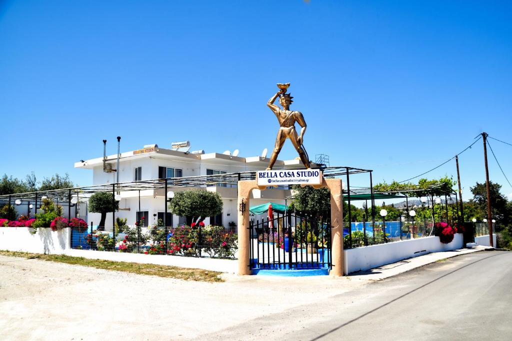 a statue of a woman standing on top of a gate at BELLA CASA KOLYMPIA in Kolimbia