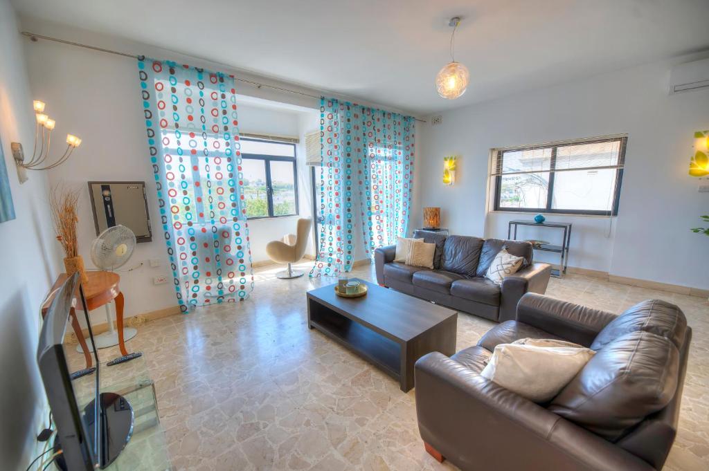 a living room with a couch and a table at Enormous 3bedrooms seafront with balcony PDEH1-1 in Sliema