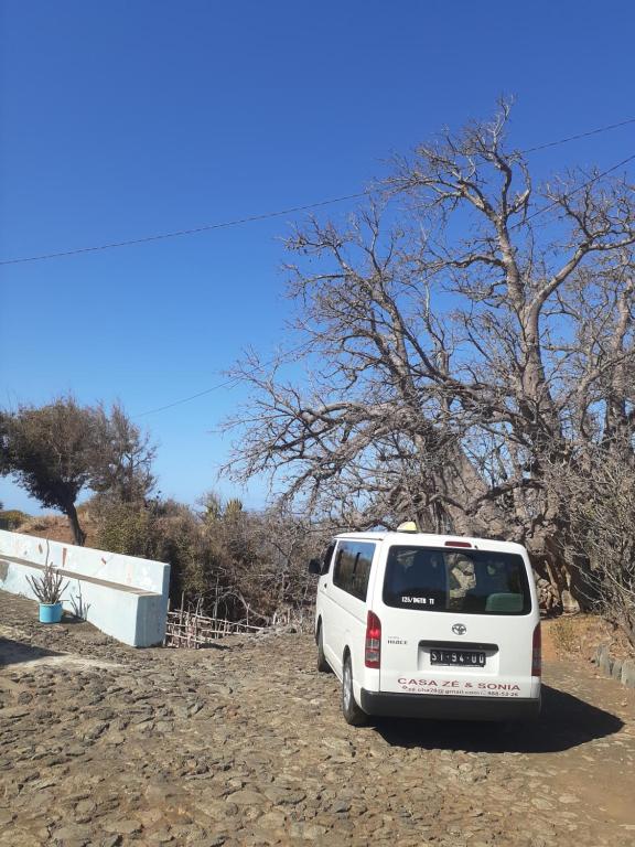 a white van parked on the side of a dirt road at Casa Ze & sonia in Portela