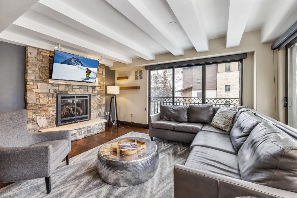 a living room with a couch and a fireplace at Spacious Luxury Unit at Lionshead Village in Vail in Vail