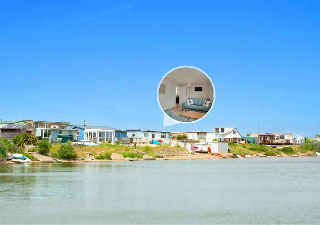 a house in a bubble over a body of water at Sailing Club Bungalow in Wolferton