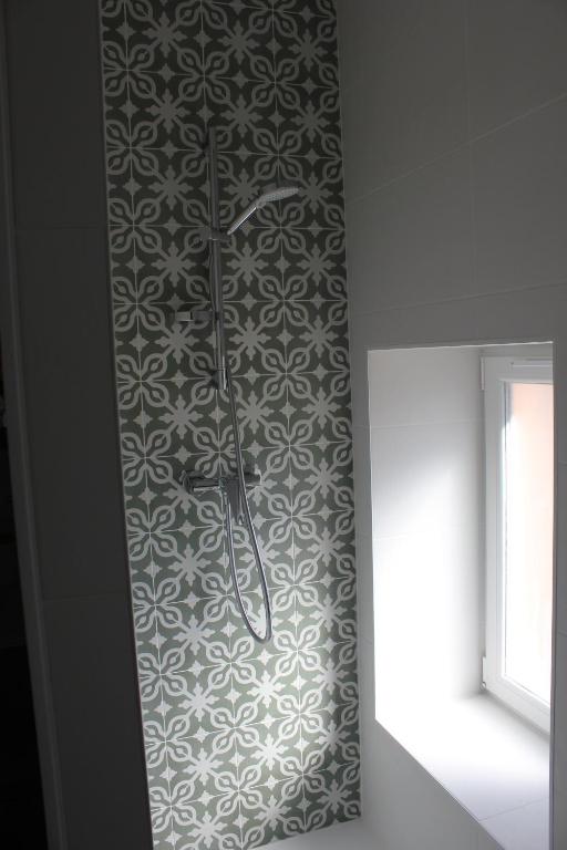 a clock on a wall next to a window at Gîte de charme pour 10 personnes in Camélas