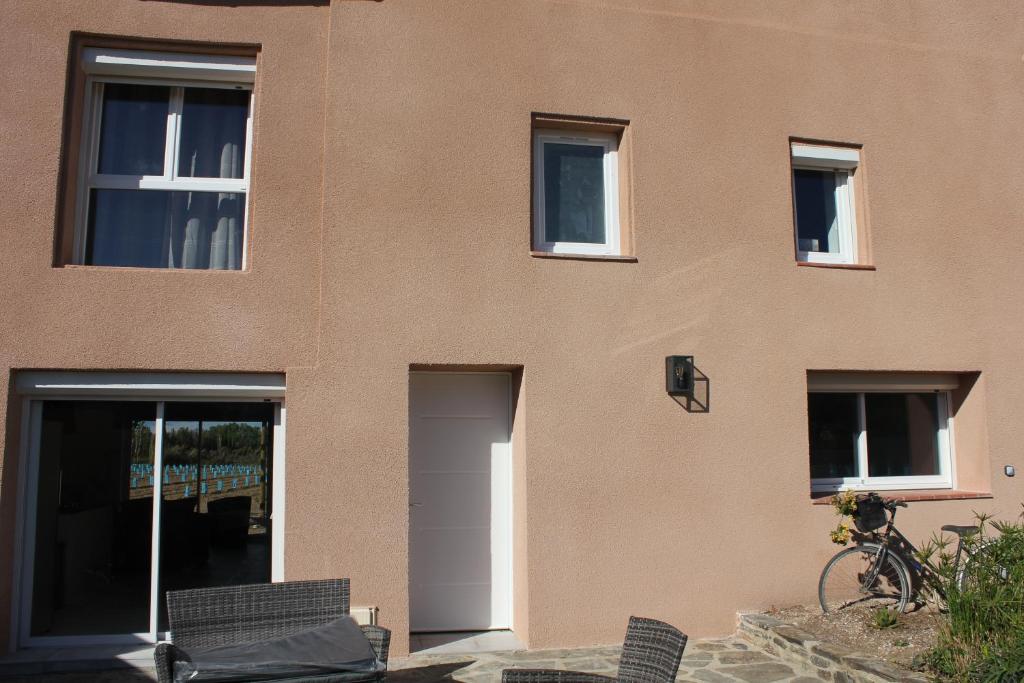 a building with chairs in front of it at Gîte de charme pour 10 personnes in Camélas