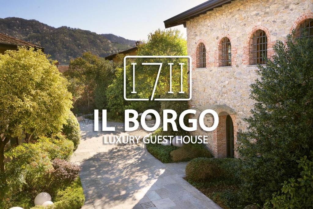a sign for a villario luxury guest house at Il Borgo - 1711 Luxury Guest House in Arlate