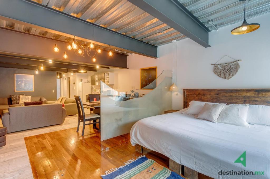- une chambre avec un lit et un salon dans l'établissement Cozy & Vibrant Loft with Rooftop & Gym in Polanco, à Mexico