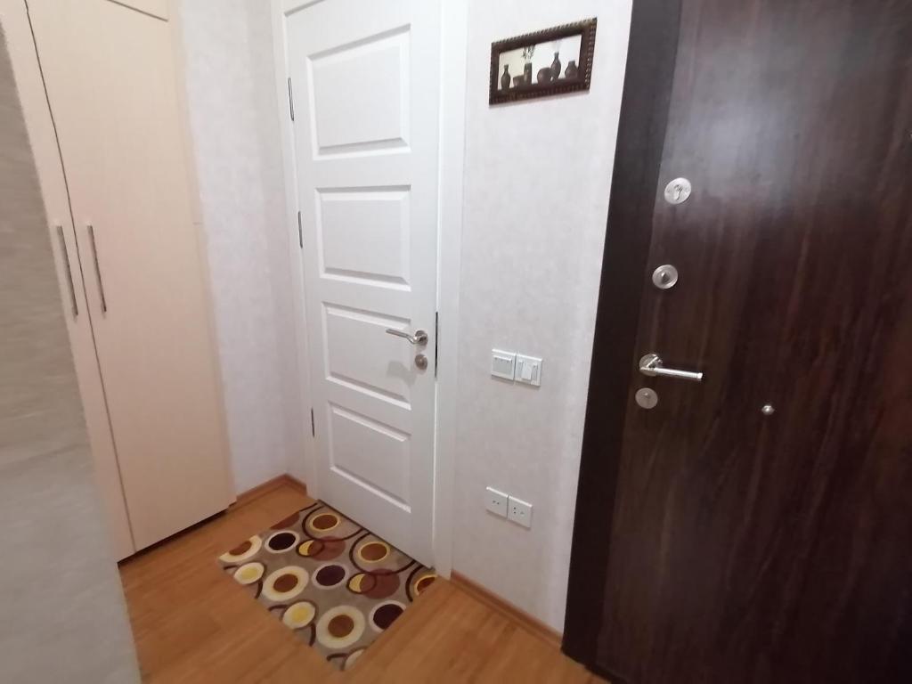 a small room with a door and a rug at Квартира in Baku