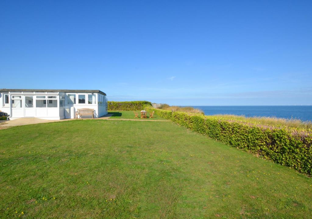 a large yard with a house and the ocean at The Lookout -Cromer in Cromer