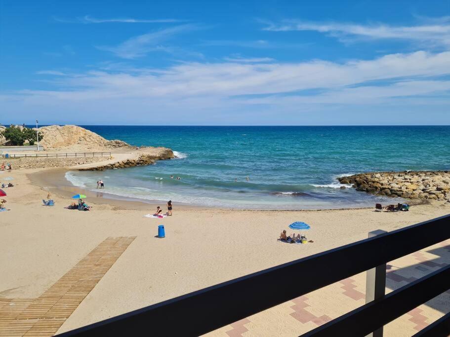 a group of people on a beach near the ocean at The perfect holiday apartment with fantastic views in Faro de Cullera