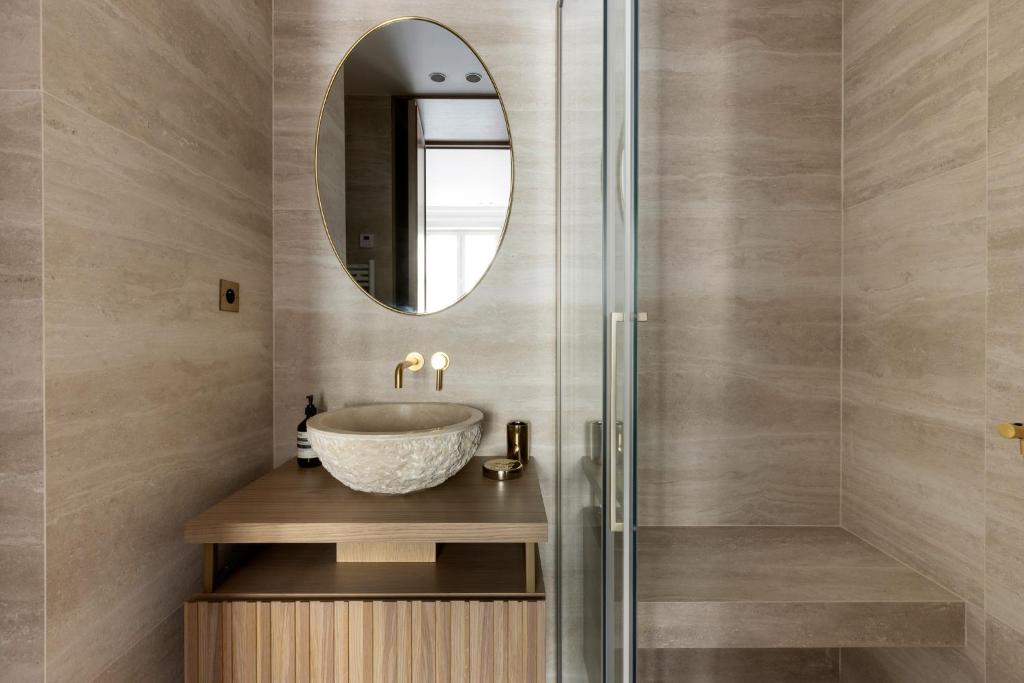 a bathroom with a sink and a mirror at HIGHSTAY - Luxury Serviced Apartments - Le Marais in Paris