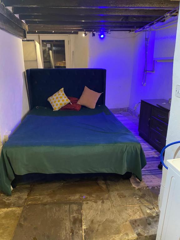 a blue bed with pillows on it in a room at The Bunker in Manchester