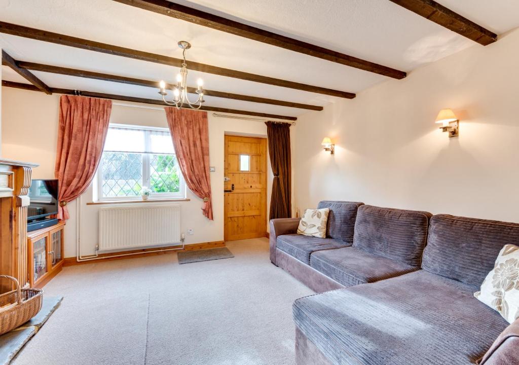 sala de estar con sofá y ventana en Tones Cottage en Great Ryburgh