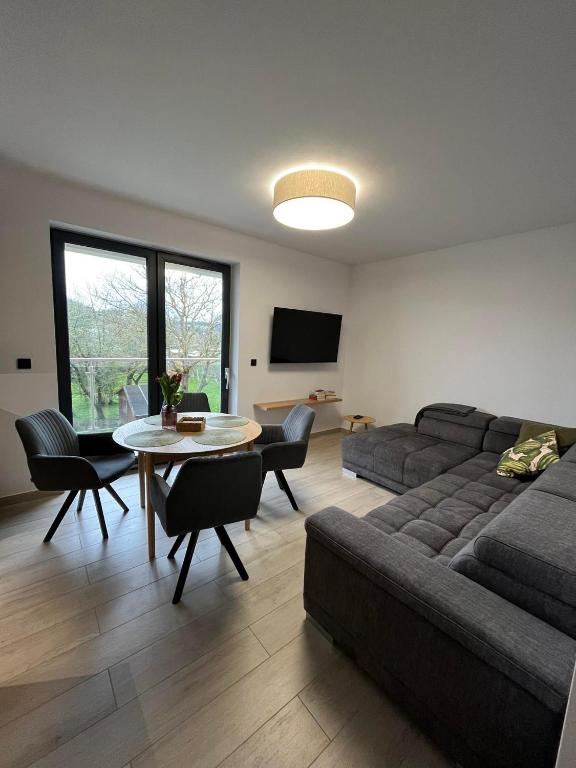 a living room with a couch and a table at Apartament w Dolinie Sanu 2 in Lesko