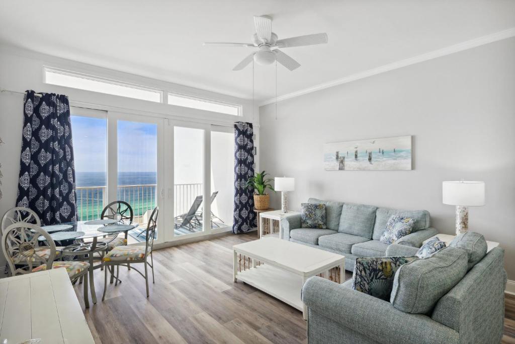 a living room with a couch and a table at Laketown Wharf #2011 by Nautical Properties in Panama City Beach