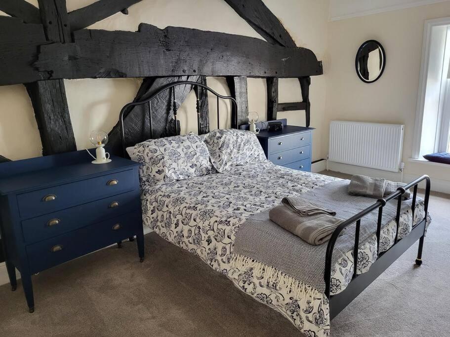 a bedroom with a bed and a blue dresser at The Hideaway in Chapel en le Frith