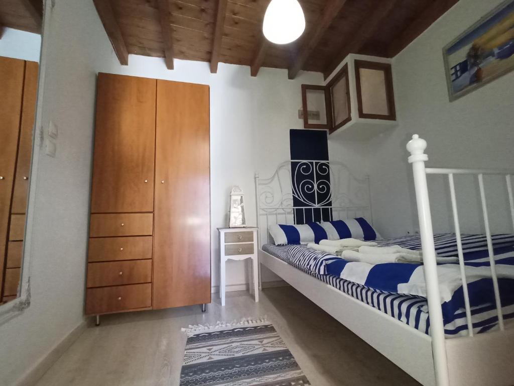 a bedroom with a bed and a wooden cabinet at The White House of Rhodes in Rhodes Town