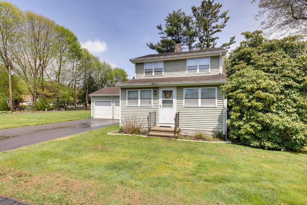 a house with a grassy yard in front of it at Charming Old Saybrook Home Half-Mi to Sand and Sea! in Old Saybrook