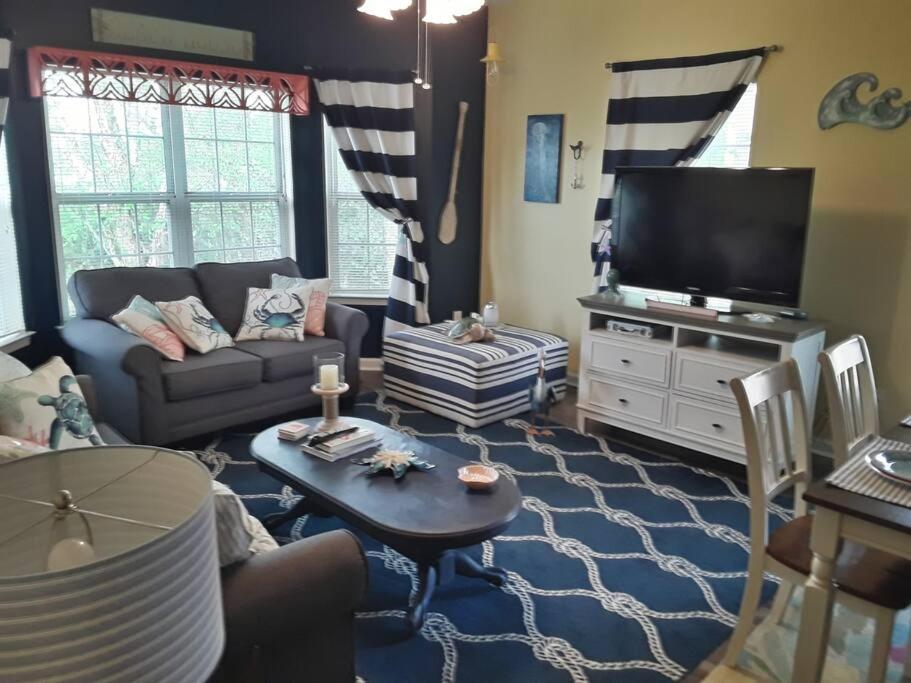 a living room with a couch and a tv at Legends Golf Beachy Condo in Myrtle Beach