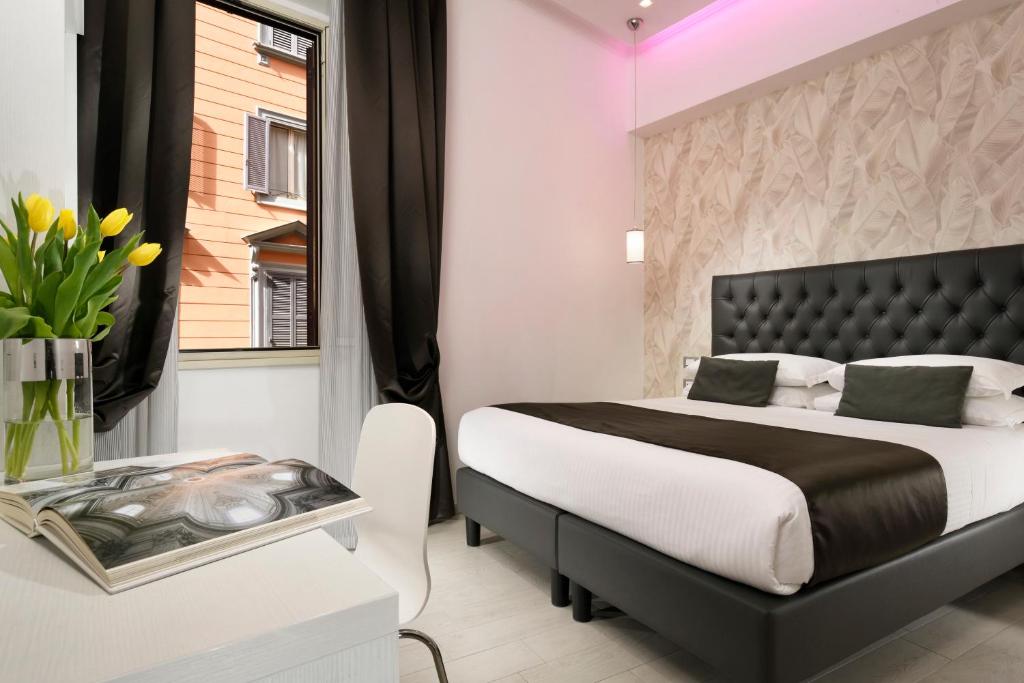 a bedroom with a black and white bed and a window at Hotel Patria in Rome