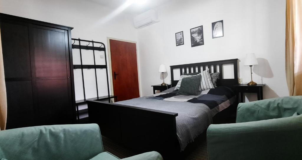 a bedroom with a bed and two chairs at Villa Gitta in Vela Luka