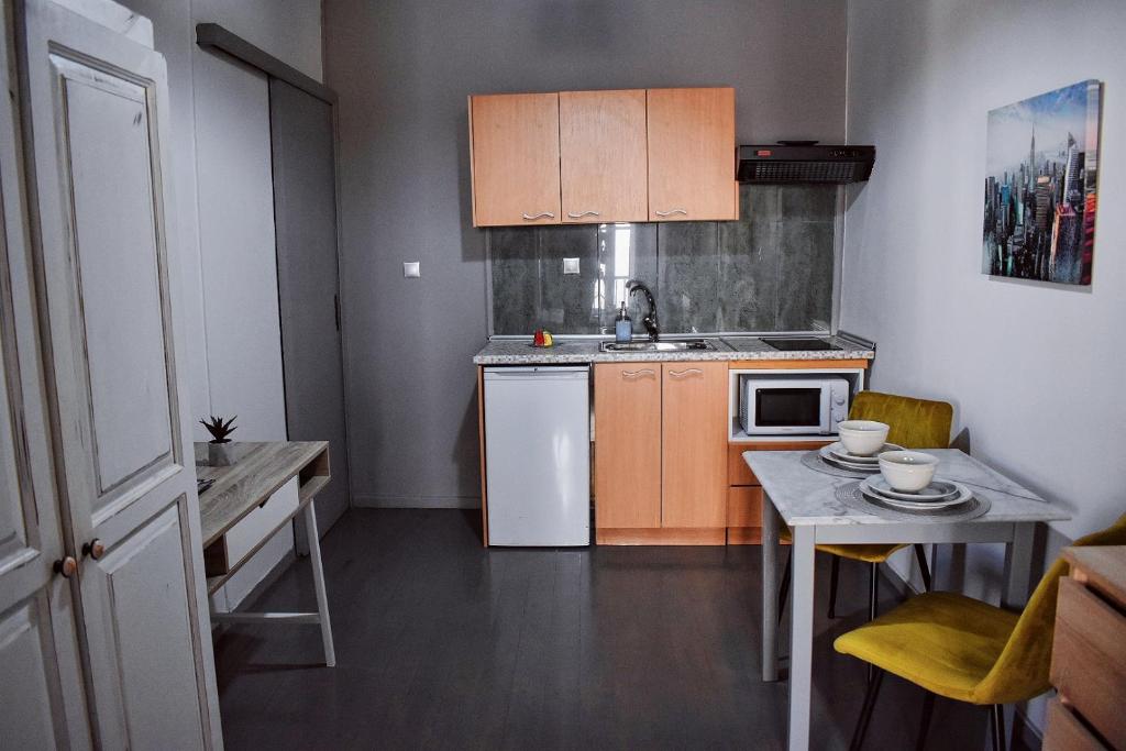 a small kitchen with a sink and a table at Cozy rooms at the old Venetian Harbor, Chania Town in Chania Town