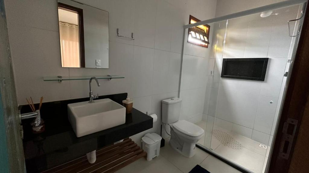 a bathroom with a sink and a toilet and a shower at Pousada dos Sonhos in Barra