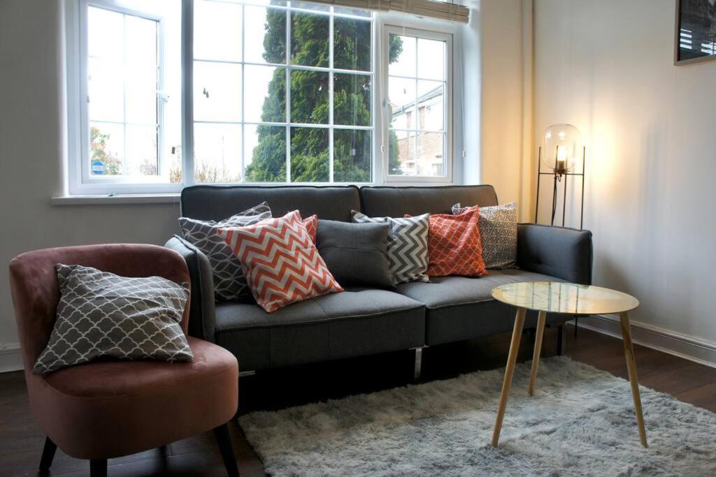 a living room with a couch and a table at Swinton, Manchester in Manchester