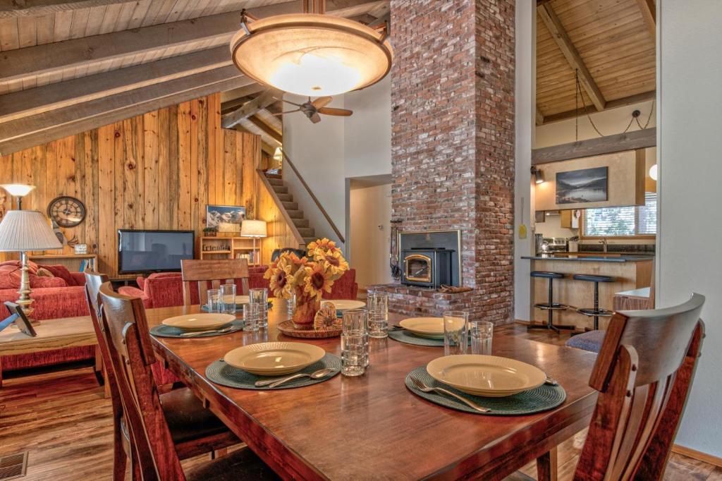 a dining room with a wooden table and a fireplace at Killdeer - Unit 6 in Sunriver
