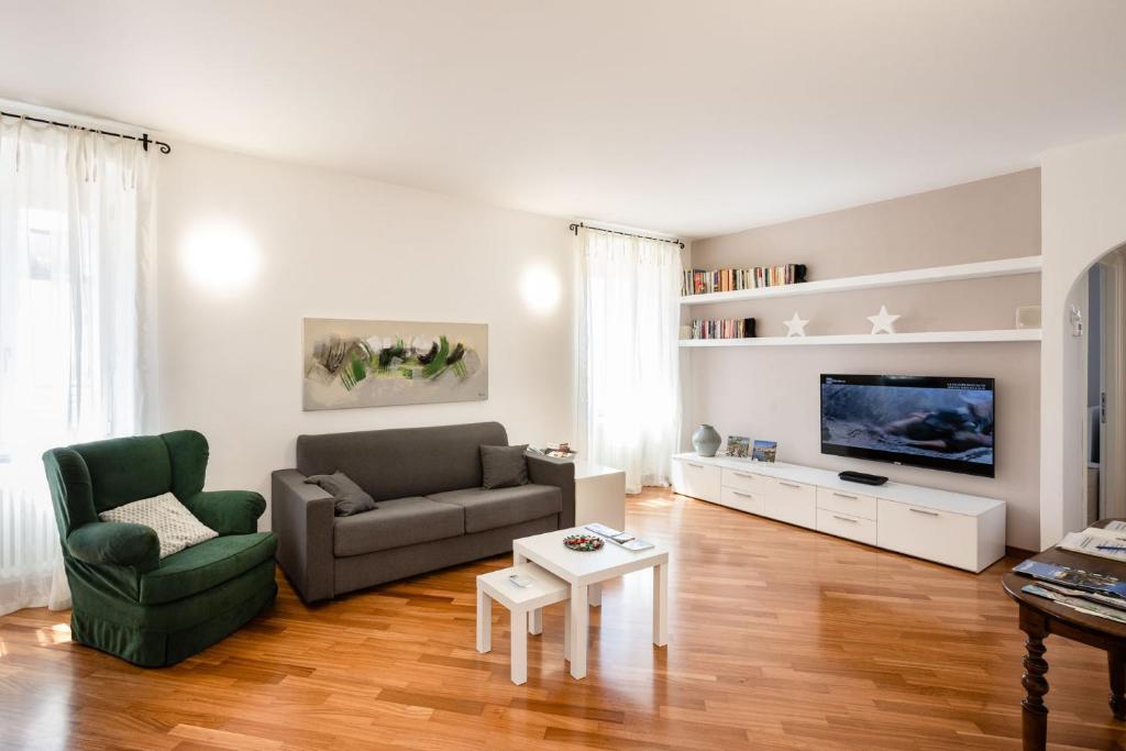 a living room with a couch and a tv at Casa mia a Nervi in Genoa