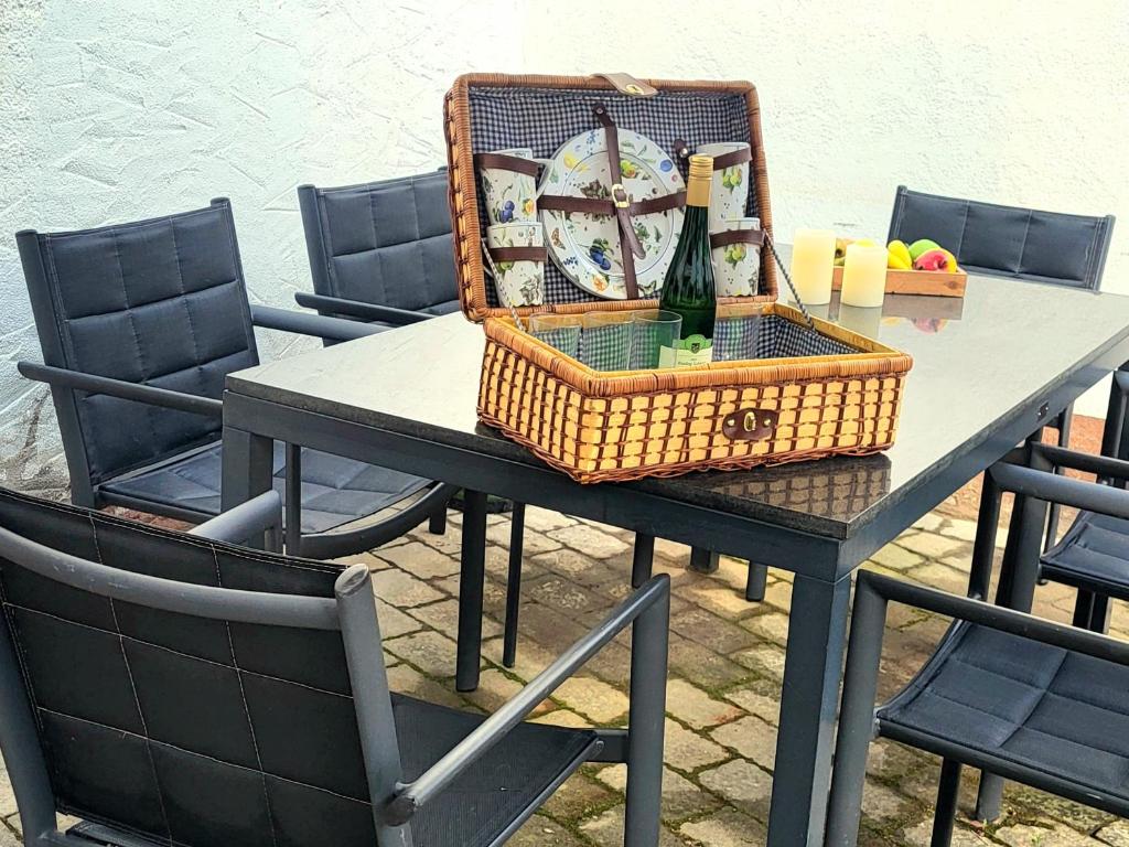 a picnic table with a basket and a bottle of wine at Haus zur Heugabel in Kesten