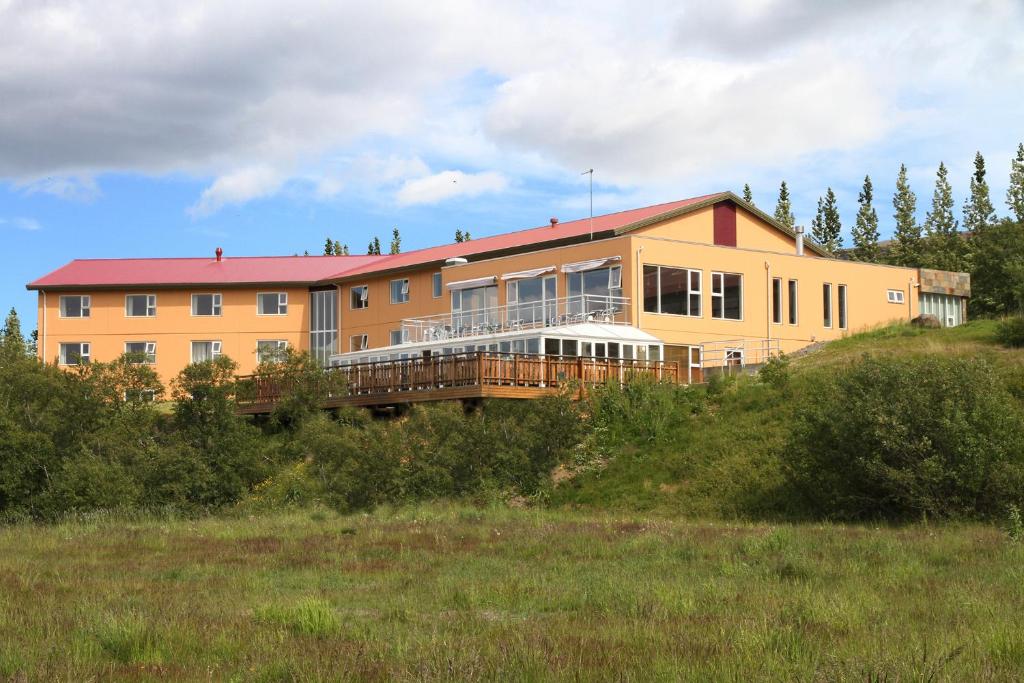 a large house on top of a hill at Hotel Hallormsstadur in Hallormsstaður