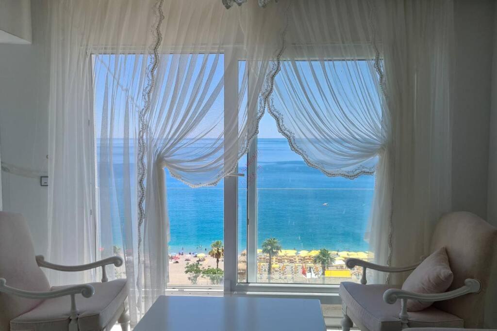 a bedroom with a large window with a view of the ocean at Antalya Konyaaltı Plajında dublex GEMİ EV in Antalya