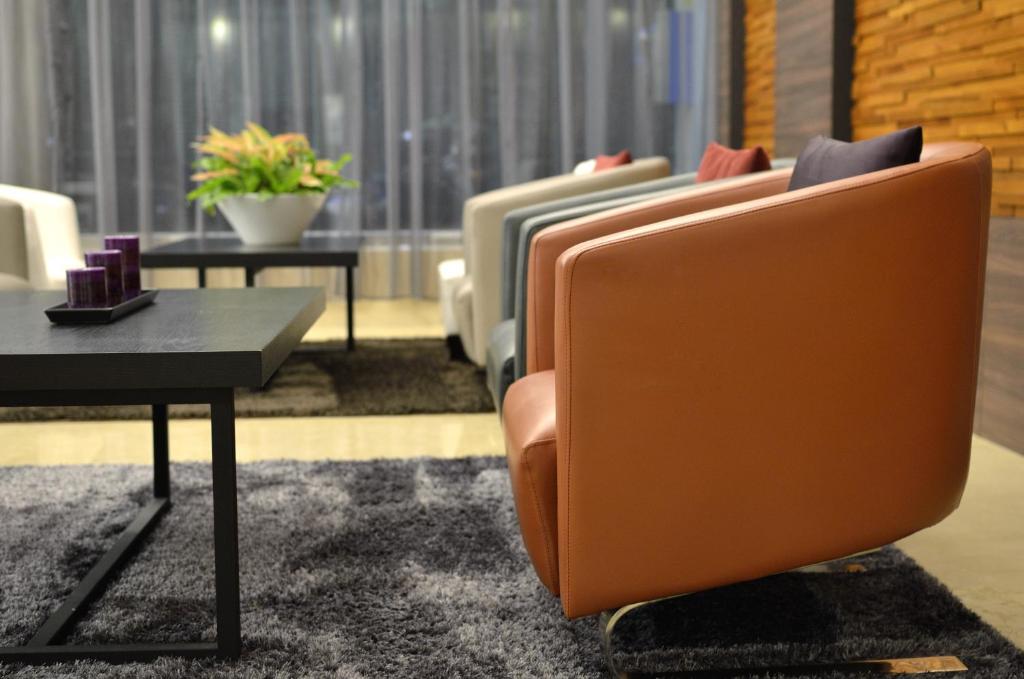 a living room with two chairs and a table at Guanko Hotel in Chiayi City