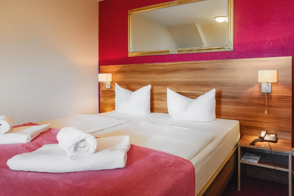 Habitación de hotel con 2 camas y toallas. en Hotel Mira Mare, en Heiligenhafen