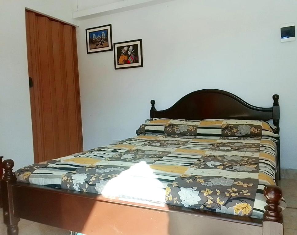 ein Bett mit einer Decke in einem Schlafzimmer in der Unterkunft Giuli Room in San Salvador de Jujuy