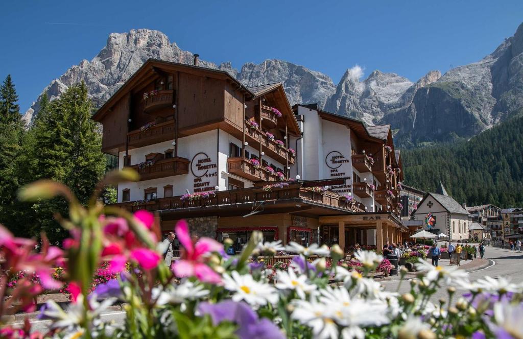 a group of flowers in front of a building at Hotel Cima Rosetta - BW Signature Collection in San Martino di Castrozza