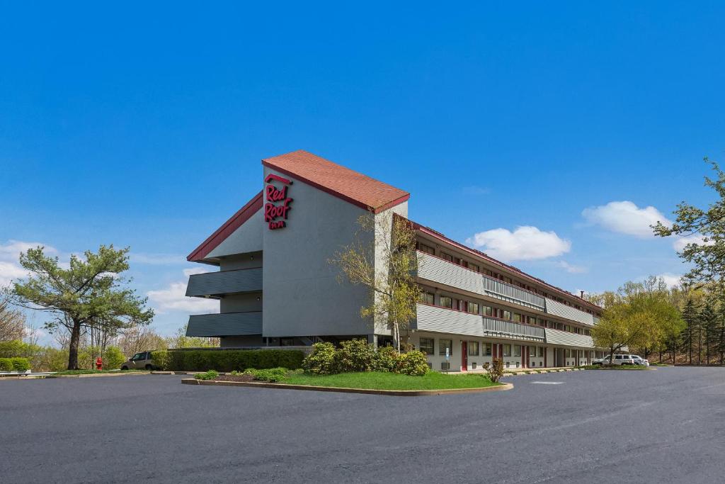 a large building with a parking lot in front of it at Red Roof Inn Wilkes-Barre Arena in Wilkes-Barre