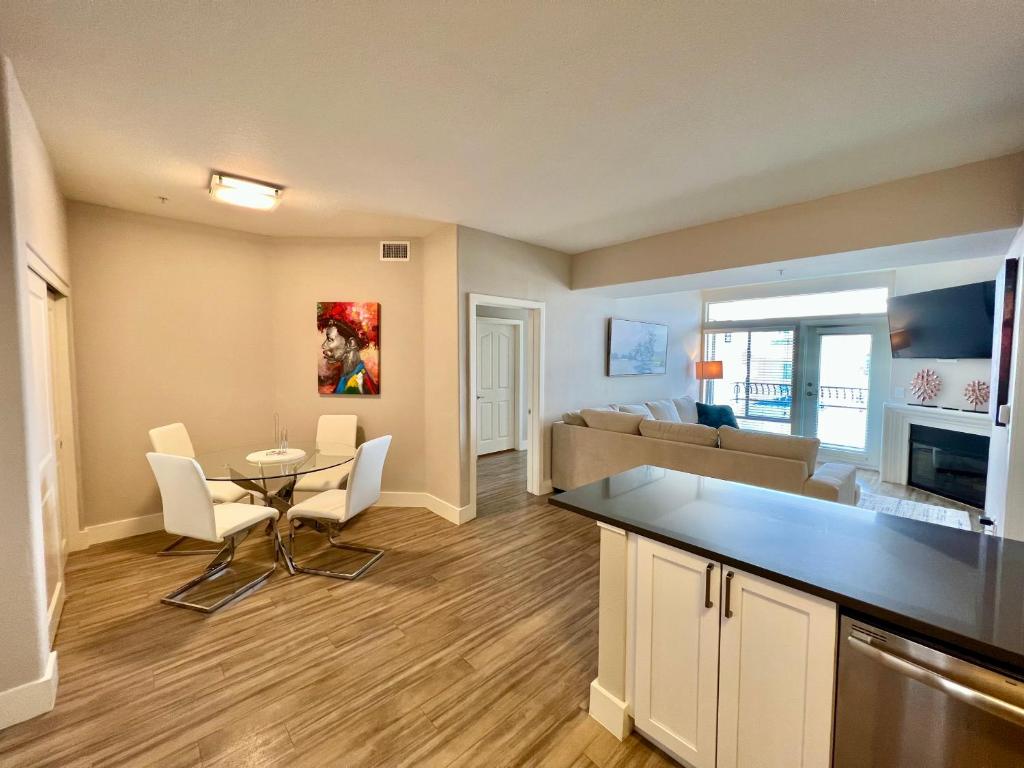 a kitchen and living room with a table and a couch at Spacious 2 Bedroom 2 Bathroom In Gated Community in Los Angeles
