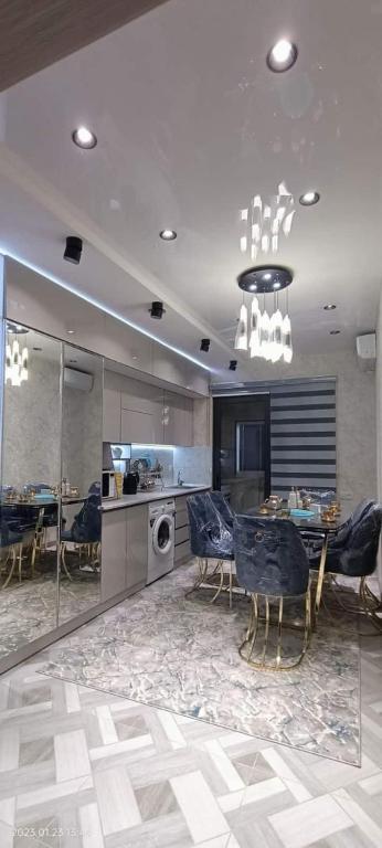 a kitchen and dining room with a table and chairs at Luxury Apartment in the Center 6 in Tashkent