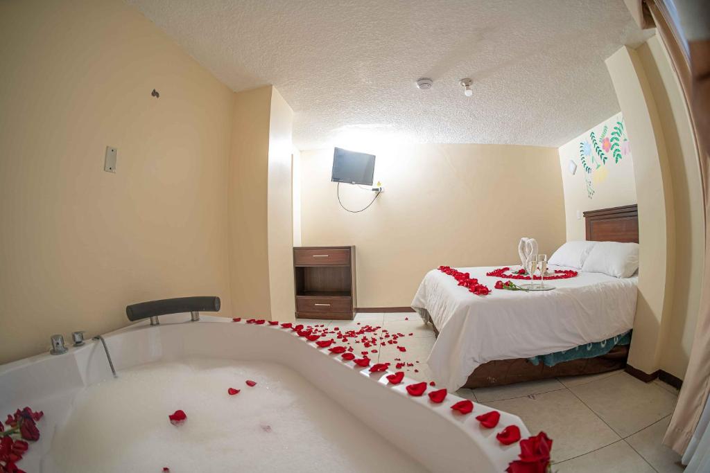 Postel nebo postele na pokoji v ubytování Hotel Tungurahua