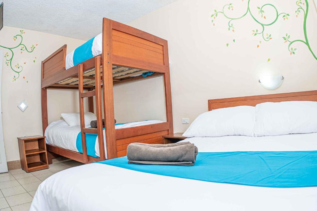 Postel nebo postele na pokoji v ubytování Hotel Tungurahua