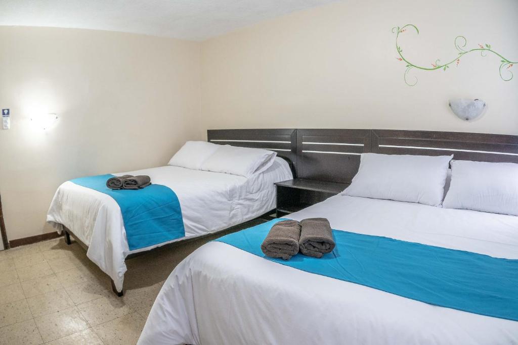 Postel nebo postele na pokoji v ubytování Hotel Tungurahua