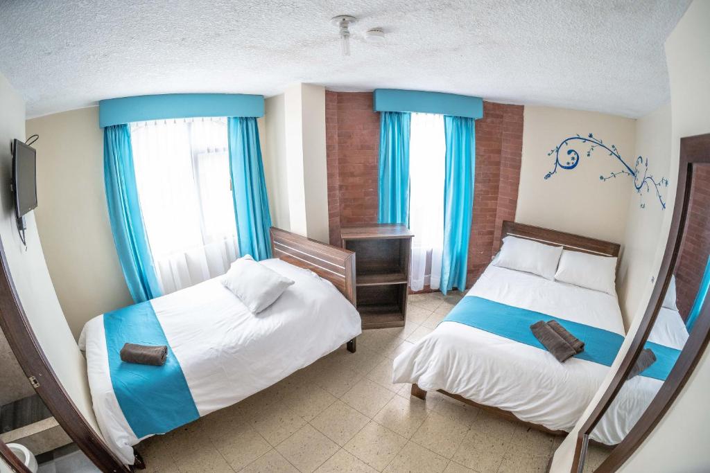 Postel nebo postele na pokoji v ubytování Hotel Tungurahua