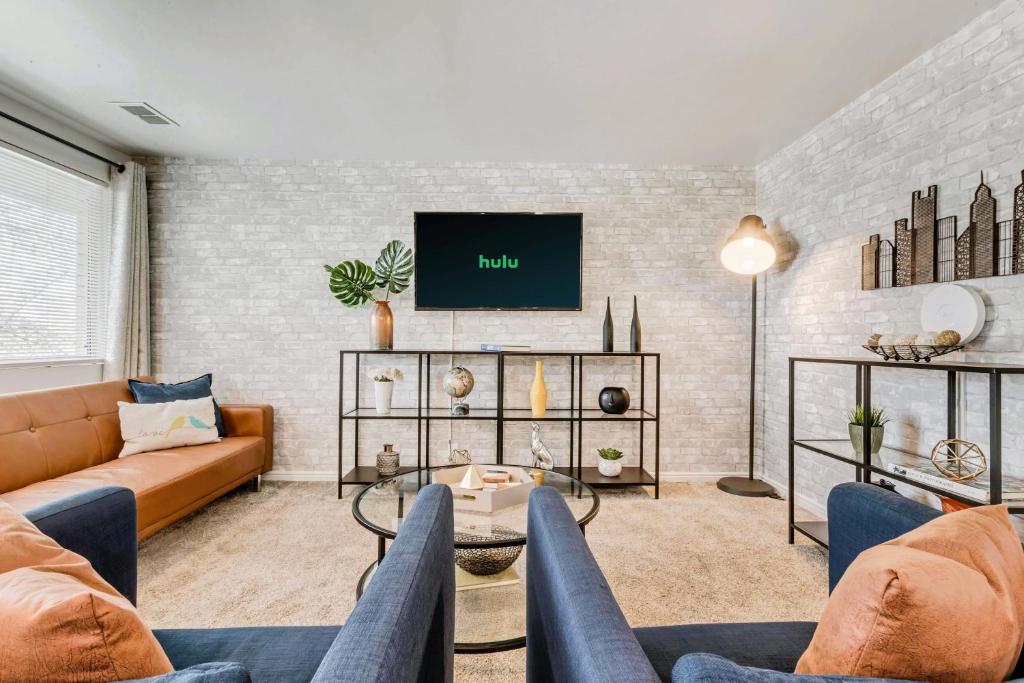 a living room with a couch and a tv at Close to Downtown - K and Q Beds - Parking in Salt Lake City