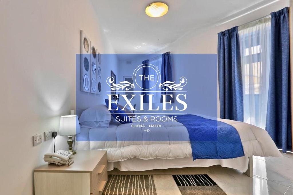 a bedroom with a sign that reads the exiles suites and rooms at The Exiles Hotel in Sliema