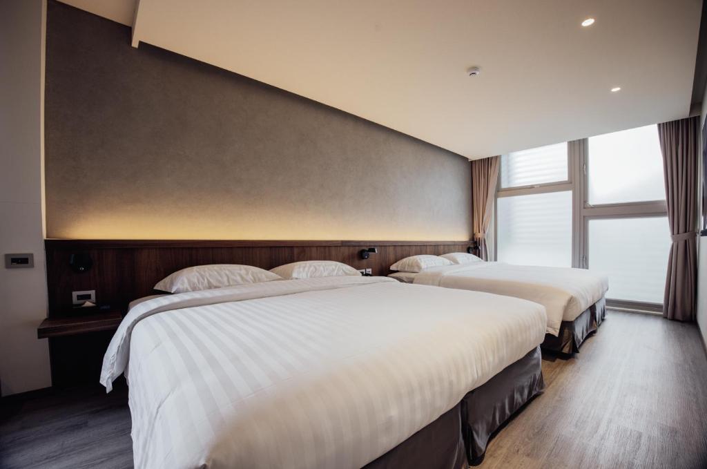 Postel nebo postele na pokoji v ubytování Hotel BEGINS 倉箱蜜境文旅