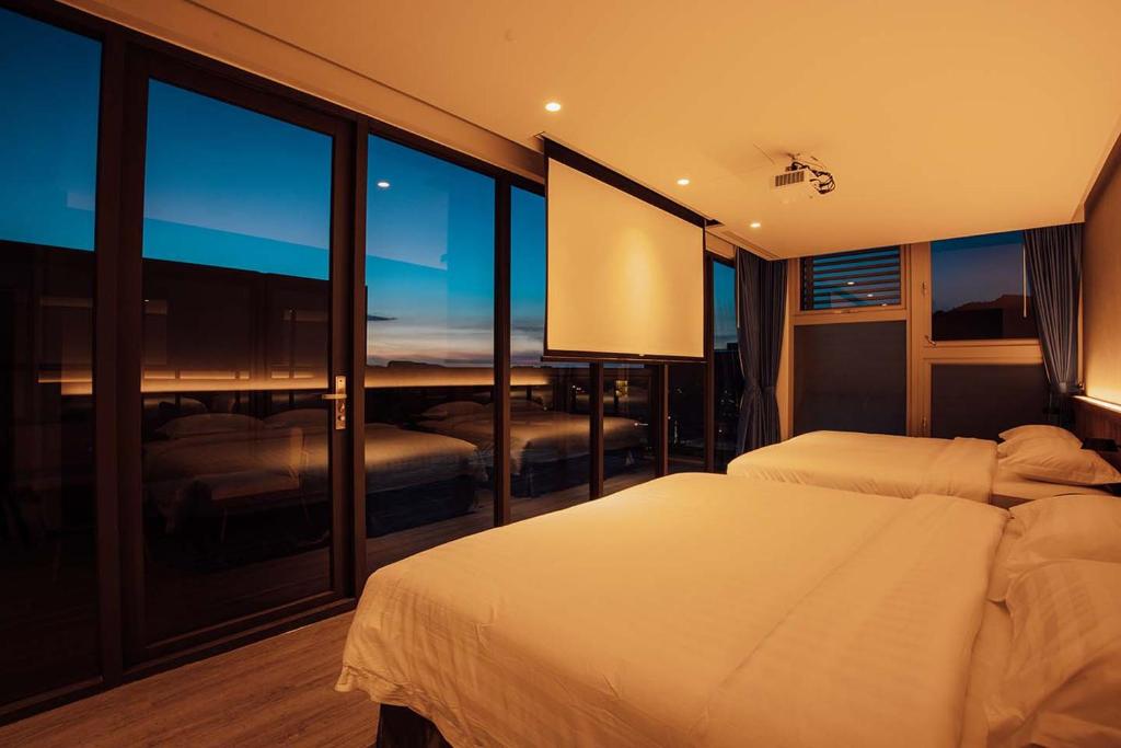 Postel nebo postele na pokoji v ubytování Hotel BEGINS 倉箱蜜境文旅