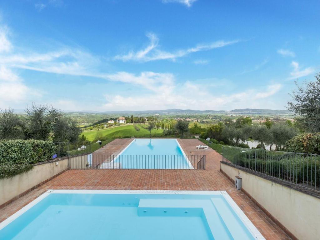 a swimming pool in the backyard of a house at Belvilla by OYO Appartamento Panorama in Asciano
