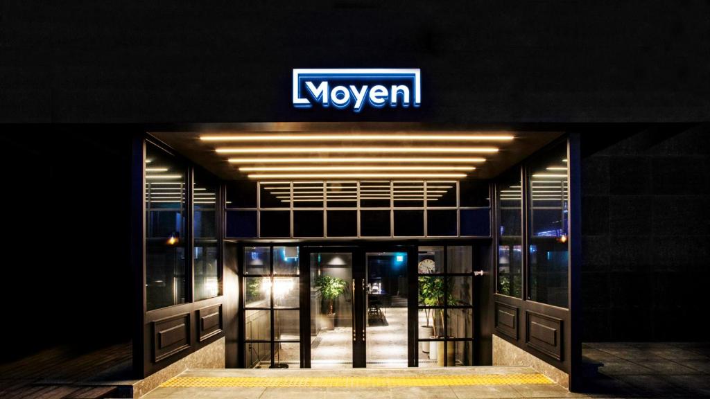 a building with a sign on top of it at Moyen Hotel in Sokcho