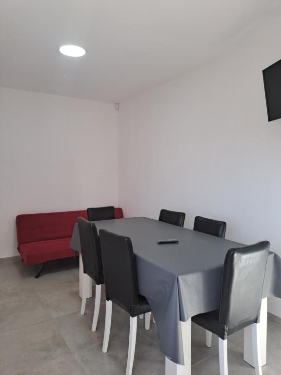 a conference room with a table and black chairs at Departamento RAWSON CALLE MITRE 956 in Rawson